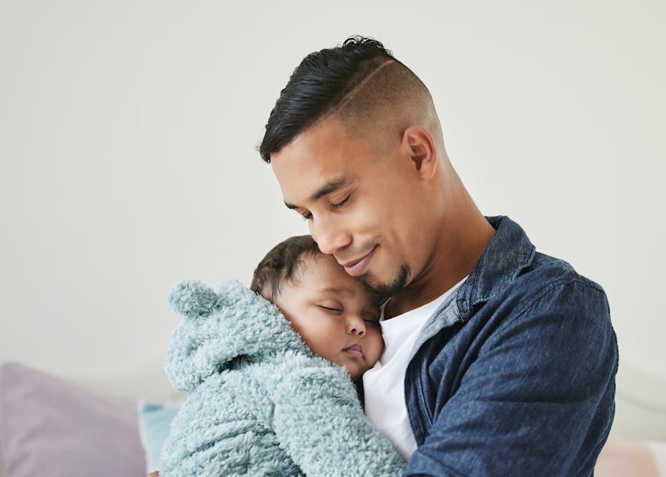 Parent comforting a sleeping child