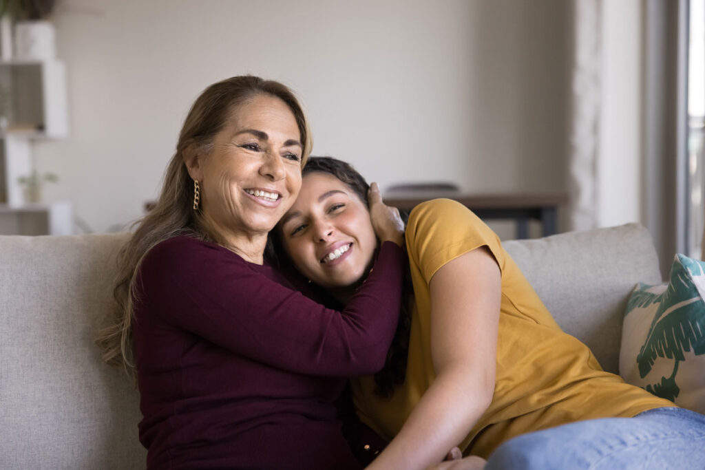 Mother and daughter embracing at home