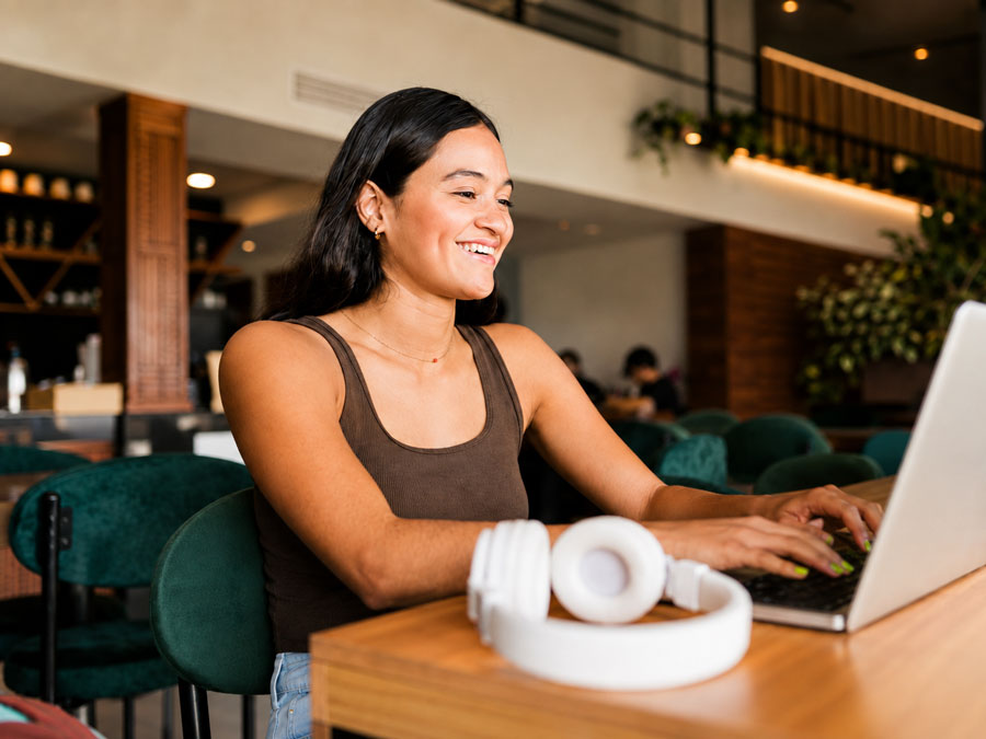 Woman working on a laptop at a table